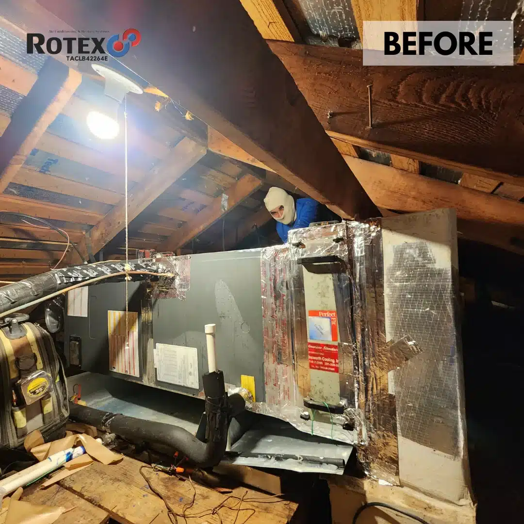 Man working in attic on hvac equipment