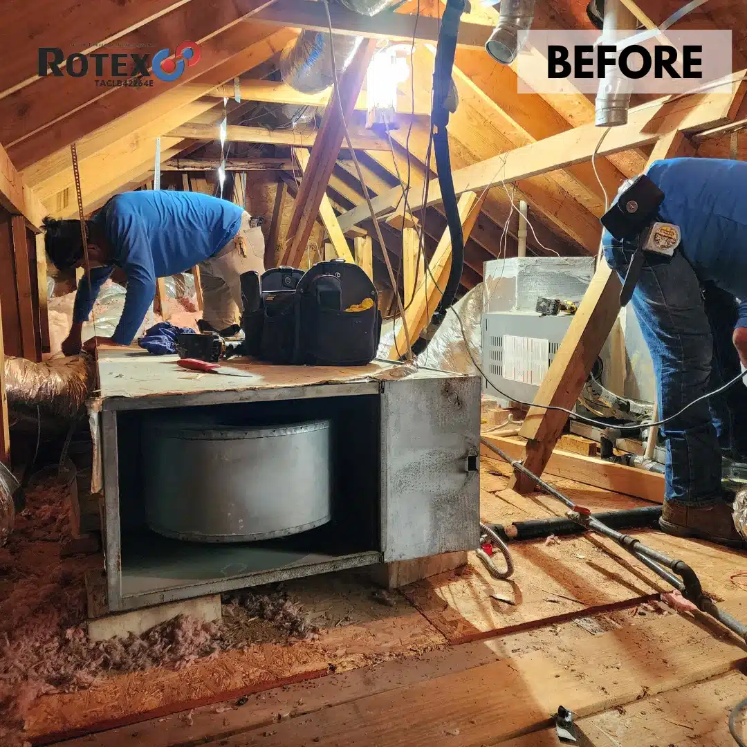 Workers installing air conditioning unit