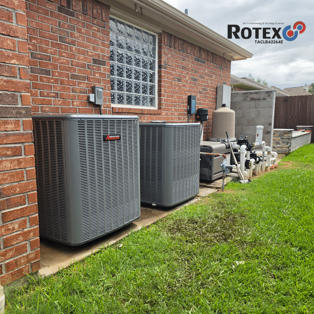 Two HVAC units beside a house.