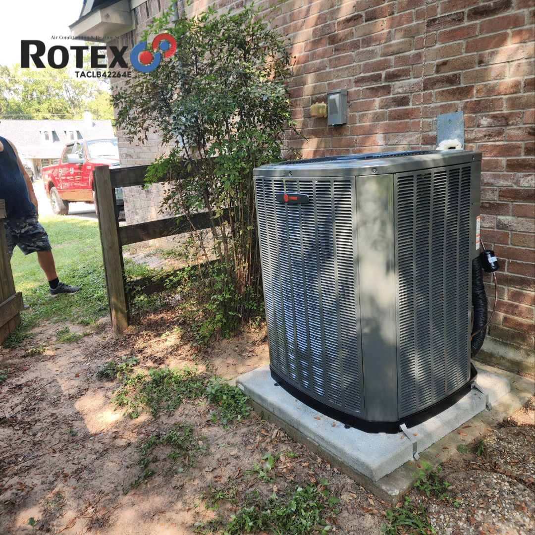 New HVAC unit beside brick house