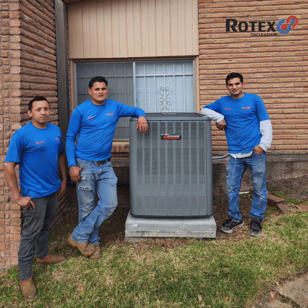 Three men beside an HVAC unit.