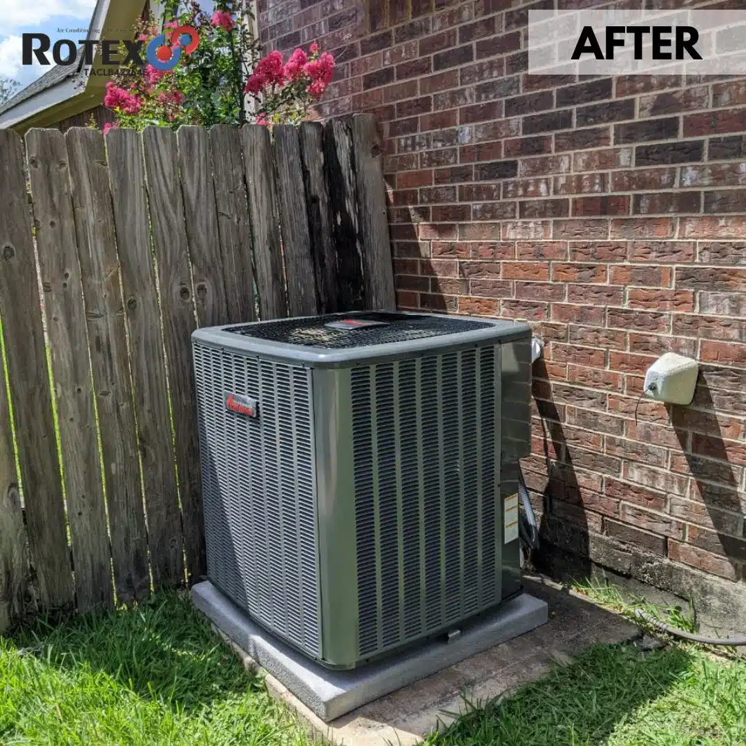 New HVAC unit beside wooden fence